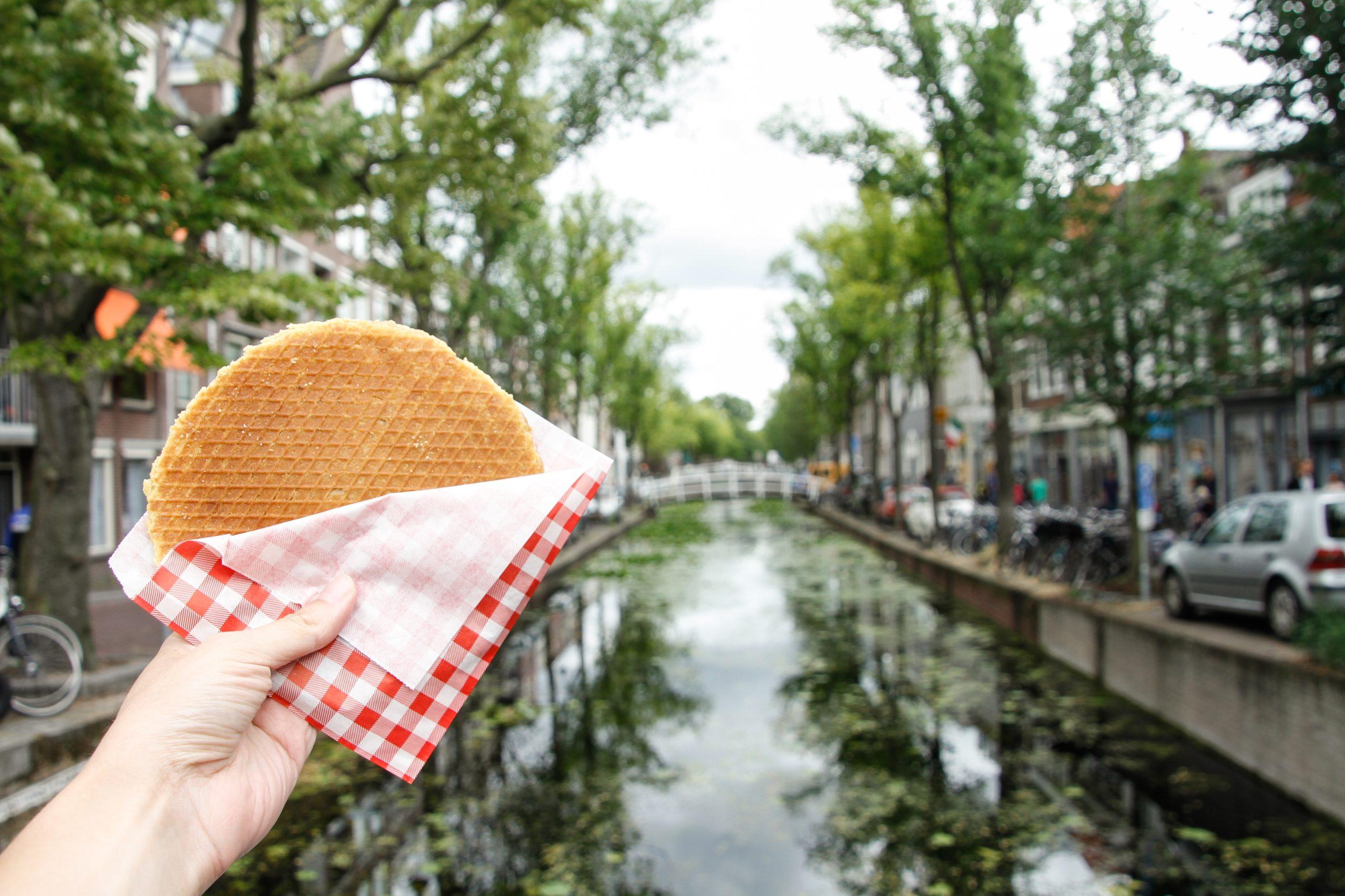 Typical,Dutch,Stroopwafel,With,The,Canal,In,The,Background